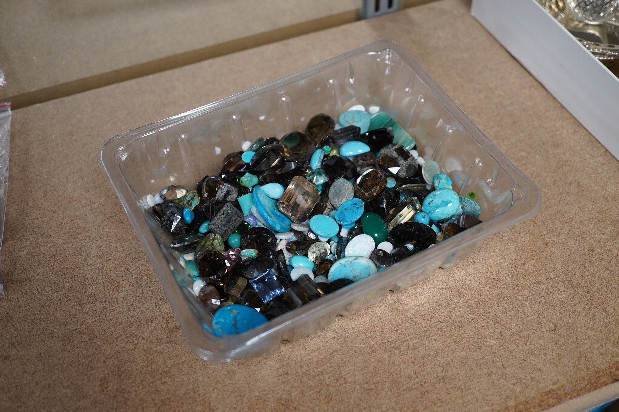 A large quantity of assorted unmounted cut and cabochon gemstones etc, including opal, quartz and turquoise. Condition - poor to fair to good